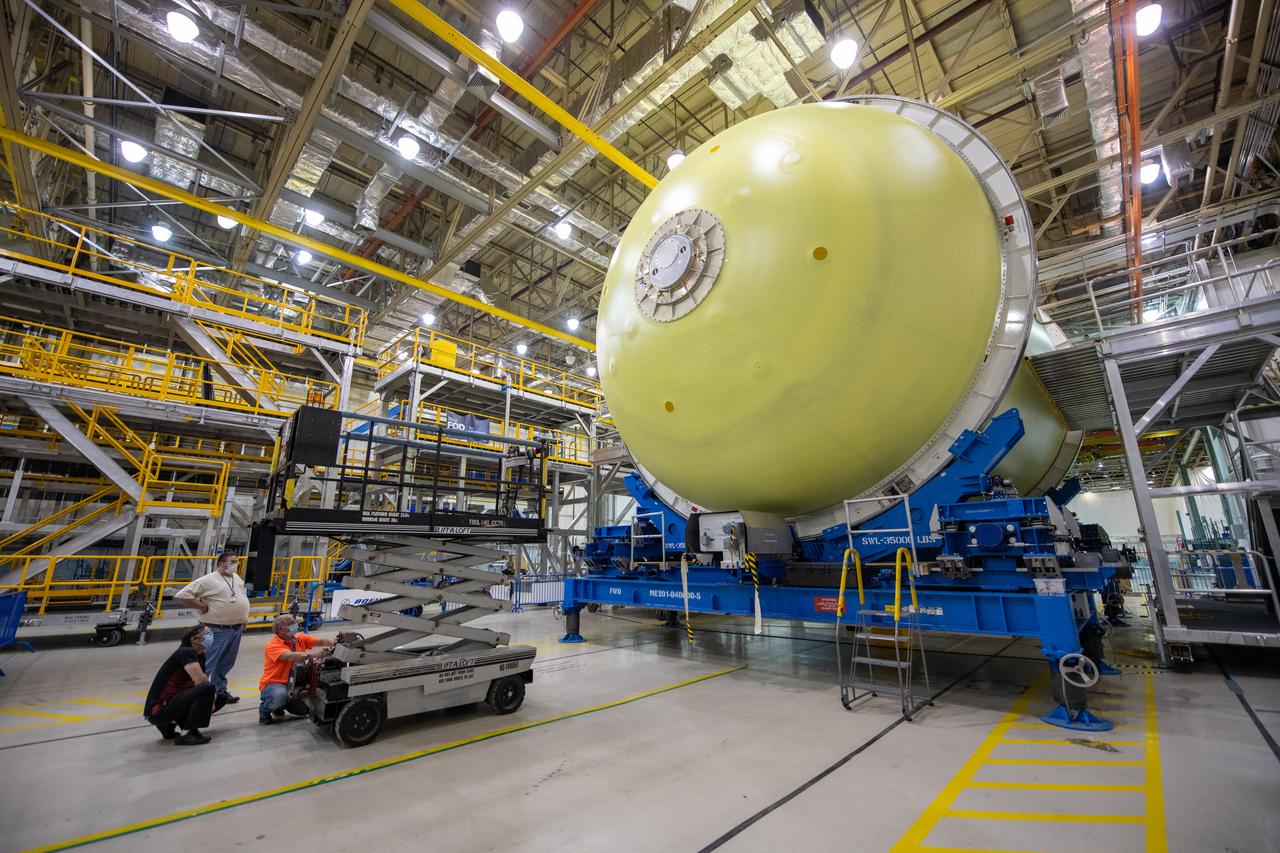 Employees wear personal protective gear at  Michoud Assembly Facility as the facility transitioned to Stage 3 of NASA’s Framework for Return To On-Site Work. Employees wear the appropriate personal protective equipment (PPE) and/or cloth face coverings as required for assigned tasks. Access to the facility is limited to authorized personnel working on mission-critical tasks that must be conducted onsite. Mission-critical tasks include slowly and methodically resuming Space Launch System (SLS) Core Stage and Orion production activities, particularly critical path deliverables to support the Artemis Program, at a pace that limits personnel and follows federal guidelines for social distancing and use of personal protective equipment such as face masks. For more information about SLS, visit nasa.gov/sls.
